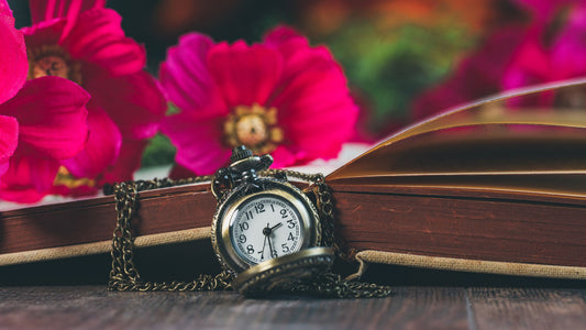 A clock surrounded by flowers, representing the extended biological timeline of ovarian aging before menopause