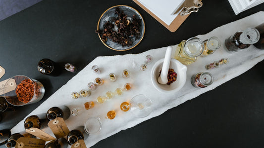 A collection of herbal preparations including teas, tinctures, oils, and powders displayed on a wooden surface
